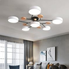 a living room filled with furniture and lots of lights on top of the ceiling above