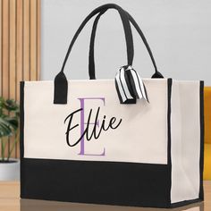 a black and white tote bag sitting on top of a table