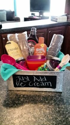 a kitchen counter with a sign that says just add ice cream and some condiments in it