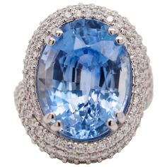 This incredible GIA Certified Ceylon sapphire ring is a one of a kind piece created at Dr. Gold Jewelry and Diamonds. The center oval cut Sapphire weighs 15.67 carats and measures 16.69 x 12.71 x 9.04 mm. The sapphire color is a bright bold beautiful blue. There are 2.30 carat total weight of round brilliant cut diamonds pavé set around the center smoothly swirling around, continuing the flow down the sides. It is a true timeless treasure that can be passed down to future generations. The ring i Ceylon Sapphire Ring, Sapphire Cocktail Ring, Ceylon Sapphire, Sapphire Color, Diamond Cocktail Rings, Sapphire Diamond, Round Brilliant Cut Diamond, Cocktail Ring, White Gold Rings