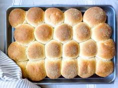 a pan filled with bread rolls on top of a table