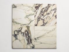 two square marble tiles with brown and white designs