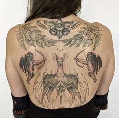 the back of a woman's body with tattoos on her upper and lower back