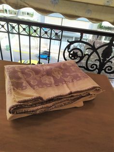 two folded towels sitting on top of a table