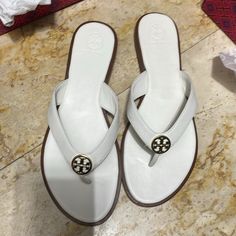 Beautiful Sandals For Tory Burch ,New I Only Tried It In The Store Comes With The Box , Ivory Color With Gold . My House Pet Free Smoke Free White Classic Sandals With Single Toe Strap, Classic White Sandals With Single Toe Strap, Luxury White Sandals With Single Toe Strap, White Flip Flops With Single Toe Strap, Classic White Sandals For Vacation, Classic White Flat Sandals, Classic White Leather Sandals, White Leather Toe Post Sandals, Designer White Sandals With Cushioned Footbed