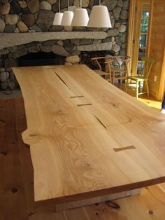 a large wooden table sitting in front of a fire place