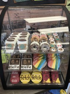 a display case filled with lots of different types of cookies and pastries on top of each other