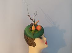 PLEASE NOTE THE HAT YOU WILL RECEIVE WILL BE EXACTLY LIKE THIS BUT IT WILL SIT AT THE OPPOSITE SIDE OF THE HEAD SO IT WILL SIT ON THE LEFT SIDE OF YOUR HEAD INSTEAD OF YOUR RIGHT. YOU CAN WEAR IT ON EITHER SIDE OF YOUR HEAD HOWEVER THE FRUIT WILL SIT AT A SLIGHTY DIFFERENT ANGLE THAN THE PICTURE . Green fascinator/ pillbox hat in a silky type of fabric decorated in green net and authentic vintage artificial fruit. Attaches to the head with elastic.  Gorgeous cute hat ideal for any occasion whether it's a wedding, Goodwood or a trip to the races. I have decorated it in original vintage artificial fruit ! Actual hat colour is a ever so slightly more vibrant shade of green than in the picture. PLEASE NOTE I WILL NOT BE POSTING TO GERMANY DUE TO THE NEW RULES. Handmade Fitted Vintage Fascinator, Retro Wedding Hat Fascinator, Retro Wedding Fascinator Hat, Vintage Kentucky Derby Mini Hat Headband, Retro Mini Hats For Kentucky Derby Wedding, Handmade Vintage Hat Fascinator, Handmade Vintage Hat-style Fascinator, Retro Fascinator For Kentucky Derby Party, Whimsical Fascinator For Kentucky Derby Gift