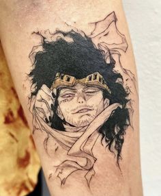 a man's arm with a tattoo on it that has an image of a person wearing