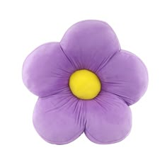 a purple flower sitting on top of a white surface