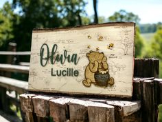 there is a sign that says ohura lucilie on the side of a wooden fence