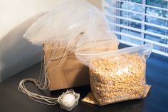 there is a bag and some food on the table next to an electronic mouse, which are also plugged in