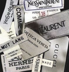 several different types of clothing labels are stacked on top of each other in this image