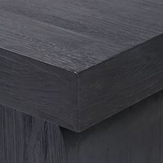 a close up view of the top of a wooden table with dark wood grains