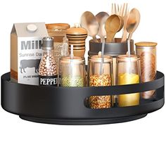 a black tray with spoons, spices and other kitchen items in it on a white background