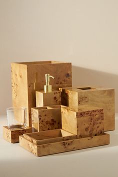 several wooden boxes with soap, toothbrushes and a glass sitting on the floor