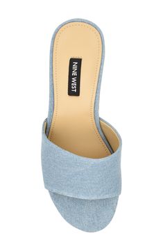 A cork-textured platform and block heel lend retro appeal to a chunky slide sandal crafted with a light-wash denim upper. 3" heel; 1 1/4" platform Textile upper/synthetic lining and sole Imported Denim Blue Open Toe Platform Heels, Summer Denim Block Heel Shoes, Summer Denim Block Heel Heels, Summer Denim Block Heel, Casual Summer Slides With Stacked Heel, Casual Slides With Branded Heel Counter For Spring, Trendy Denim Wedge Heel Sandals, Trendy Denim Sandals With Wedge Heel, Platform Slides