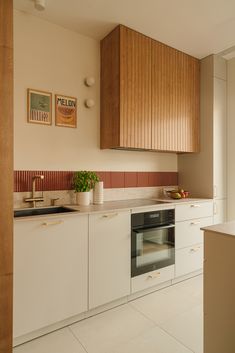 a kitchen with an oven, sink and counter top in it's center area