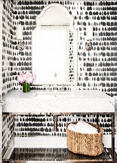 a white sink sitting under a bathroom mirror next to a wall mounted faucet