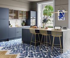 a kitchen with two bar stools next to an island in front of a window