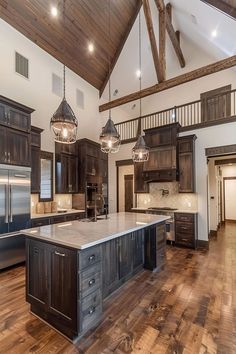 a large kitchen with wood floors and wooden beams on the ceiling is pictured in this image