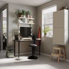 a room with a desk, chair and bookshelf