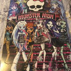 the monster high poster is on display in front of a tablecloth with skulls and skeletons