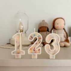 two candles that are sitting on a table