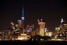 the city skyline is lit up at night