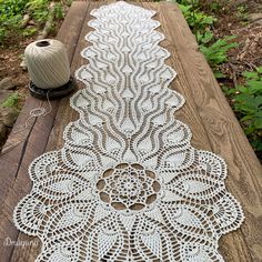 a white doily sitting on top of a wooden table