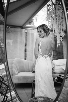 a woman standing in front of a mirror