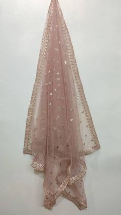 This is a Dupatta made on orders.It is made using dyeable net fabric with gold sequine embroidery all over. We make it colored as shown in the picture.Then we stitch a beautiful golden lace to all sides of it.Dupatta is having a length of 100 inches and width of around 40 inches.I don't keep it readymade I only make it exclusively for my customers.Can be fully customised. Luxury Bollywood Dupatta For Puja, Luxury Pink Slub Silk Dupatta, Cheap Embroidered Dupatta For Puja, Luxury Georgette Dupatta For Puja, Peach And Gold, Suit Salwar, Girls Party Wear, Lehenga Suit, Golden Lace