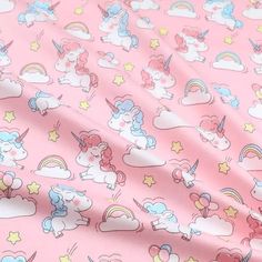 a pink fabric with unicorns and stars on it