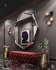 a red couch sitting in the middle of a room next to a mirror and lamp