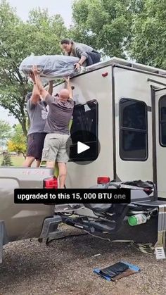 two men unloading an rv from the back