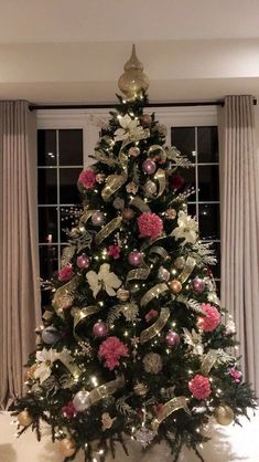 a decorated christmas tree with pink and silver ornaments