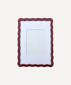 a red and white frame with a square in the middle on a white wall background