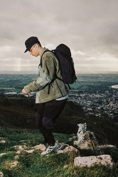 a man with a backpack walking up a hill