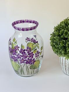 there are two vases with flowers painted on them