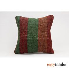 a green, red and orange striped pillow on a white background with the words enjoy stanbul