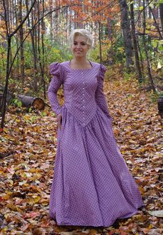 This striking dress has a rounded open neckline, front button closure and leg-o-mutton long sleeves. The waist creates a deep V in the front. This dress also features our three-paneled full skirt with pockets. Hand wash or machine wash and dry gently. 100% sturdy cotton. The model is wearing boots and a crinoline, which are priced separately. Designed and made proudly by Recollections in America! The following are approximate finished measurements and include room for ease of movement.  BustWais Fitted Dresses With Bishop Sleeves And Buttons, Victorian Dress With Buttons For Costume, Long Sleeve Dress With Gathered Sleeves For Gatherings, Peasant Long Sleeve Fitted Dress, Peasant Style Long Sleeve Fitted Dress, Peasant Style Fitted Dress With Long Sleeves, Classic Fitted Long Sleeve Prairie Dress, Fitted Peasant Dress For Fall, Fitted Prairie Dress With Gathered Sleeves