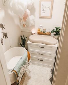 a baby's room with a crib, dresser and changing table in it