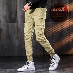 Men's Tactical Slim Fit Cargo Joggers - AM APPAREL Spring Khaki Cotton Cargo Pants, Khaki Joggers With Cargo Pockets For Streetwear, Khaki Cargo Style Joggers For Streetwear, Khaki Cargo Pocket Joggers, Trendy Khaki Cotton Cargo Jeans, Khaki Cotton Bottoms For Outdoor Activities, Khaki Techwear Cargo Trousers, Techwear Khaki Cargo Trousers, Khaki Cotton Cargo Parachute Pants