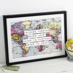 a world map with the words friends forever and maybe in distance on it next to a glass globe