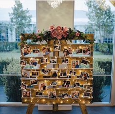 a wooden stand with pictures and lights on it