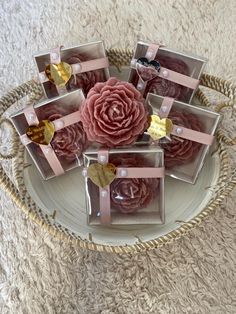 a bunch of pink flowers sitting on top of a white plate with gold foil hearts