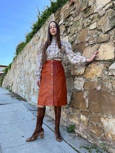 "70s Burnt Orange Leather Skirt Gorgeous seventies burnt orange leather skirt with ivory wood button closures up the front and two front pockets. I've only seen this style of buttons on a few rare 70s pieces. So beautiful! Top stitched in ivory on the pockets and button panel. This is a very special piece. Unlined. 🍑marks throughout the Entire skirt. See photos. Do NOT purchase if this bothers you.  27\" waist  38\" hip-measured at the third button down-hip measurement is key when buying sevent Retro Bottoms With Button Closure For Fall, Fall Leather Skirt With Button Closure, Retro Fall Bottoms With Buttons, Vintage Fall Skirt With Buttons, 70s Inspired Brown Bottoms For Fall, Vintage Brown Skirt With Buttons, Vintage Fall Skirt With Pockets, Retro Brown Skirt With Pockets, Fitted Skirt With Snap Buttons For Fall