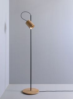 a floor lamp with a wooden base and a light bulb on the top of it