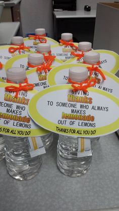 several water bottles with labels on them sitting on a table