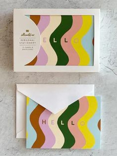 two envelopes with colorful waves on them and the word hello written in large letters